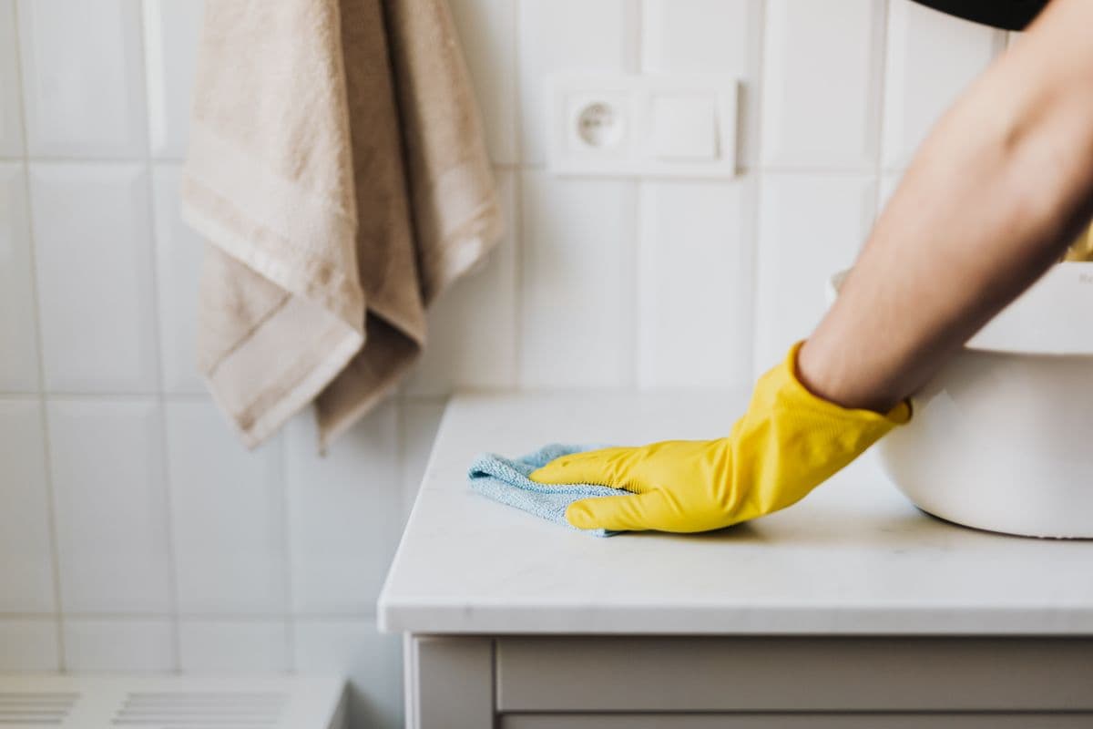 Professional cleaner wiping down a surface
